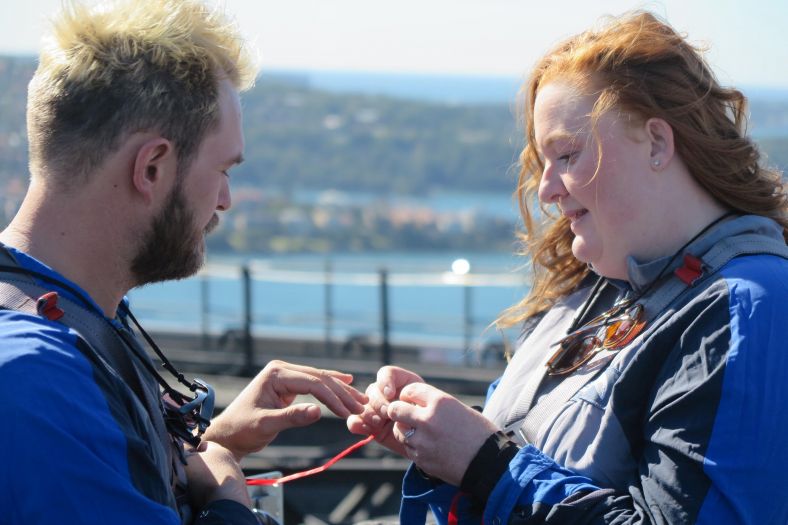 Couple exchanging rings on top of the Sydney Harbour Bridge
