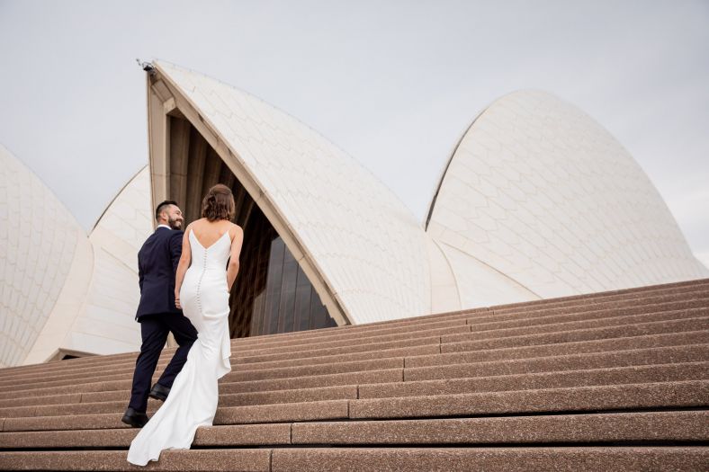 Bride and groom walking up the stairs at the Sydney Opera House