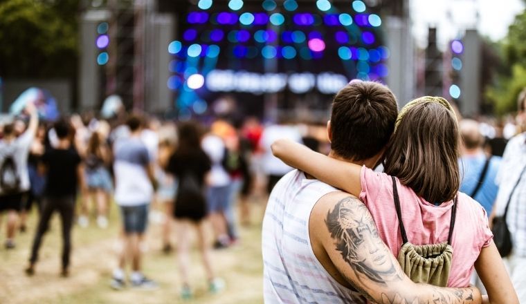 Back view of a couple embracing at a music concert