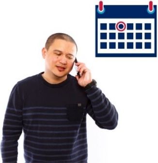 A male holding up a phone to his ear