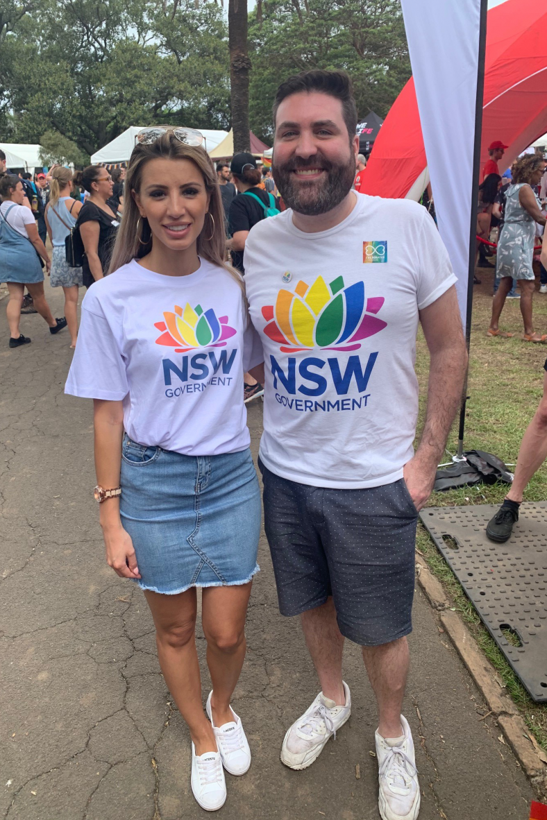 Two NSW Government staff members wearing the rainbow waratah t-shirts