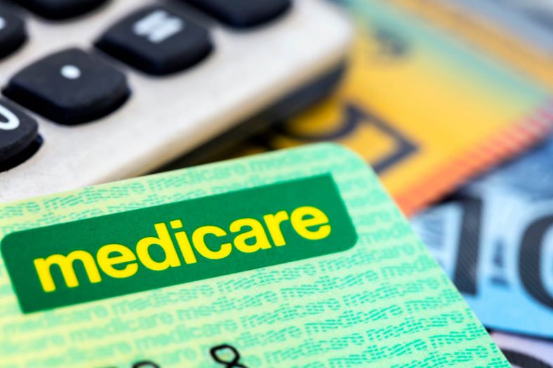 Medicare card with calculator and cash