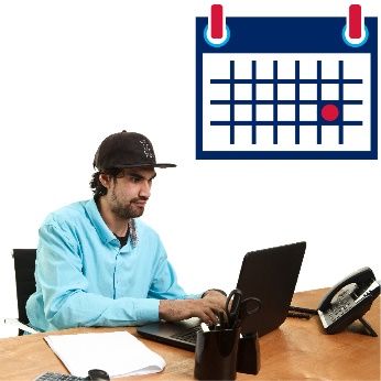 man seated at desk using laptop and accessing his calendar