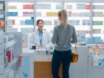 A woman buying something at a pharmacy