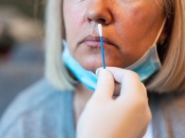 woman receiving a nose swab