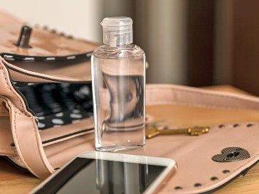 hand sanitiser bottle in woman's handbag