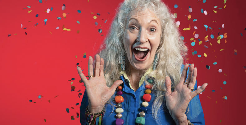 Older adult expressing excitement, showered with confetti