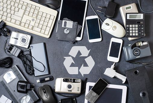 Electronic waste  in a circle, with a recycling symbol in centre