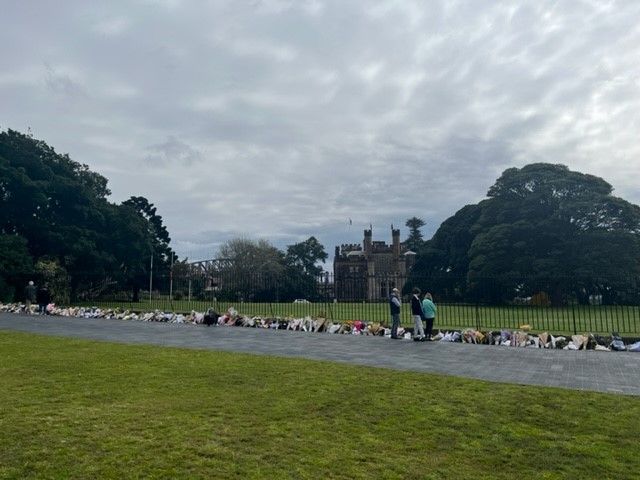 an image of citizens standing outside Government House Sydney admiring floral tributes laid out for Her Majesty Queen Elizabeth II 