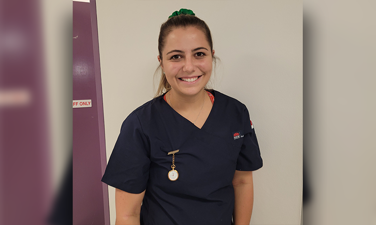 Smiling young woman in nurses uniform