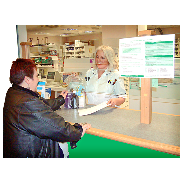 woman at pharmacy counter speaking with pharmacist
