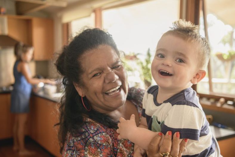 Photo of Aboriginal and Torres Strait Islander grandma with grandchild in kitchen
