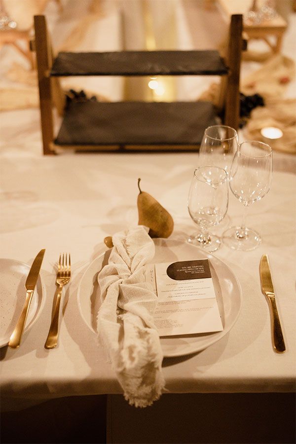 Table styling with a menu, crockery and a pear