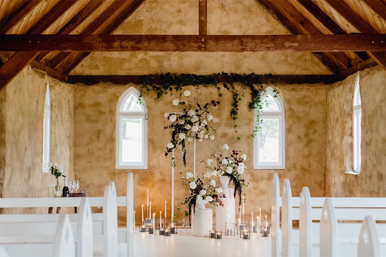 The chapel styled with flowers and candles. 