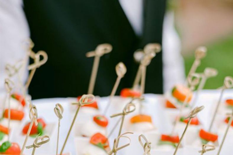 A waiter holding a tray of canapes
