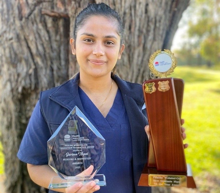 Registered Nurse Garima Nepal receives award trophies