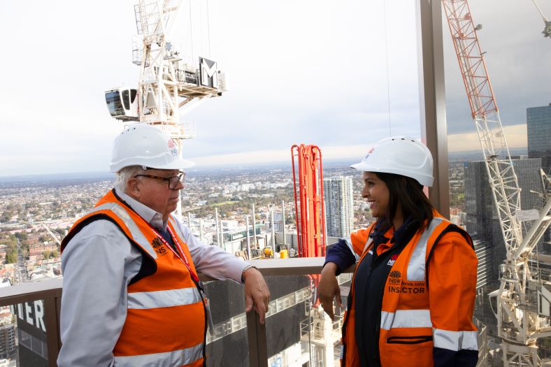 David Chandler, NSW Building Commissioner talking to woman on building site