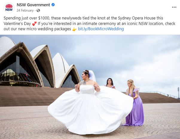 Bride at the Opera House in wedding dress with two bridesmaids holding her dress