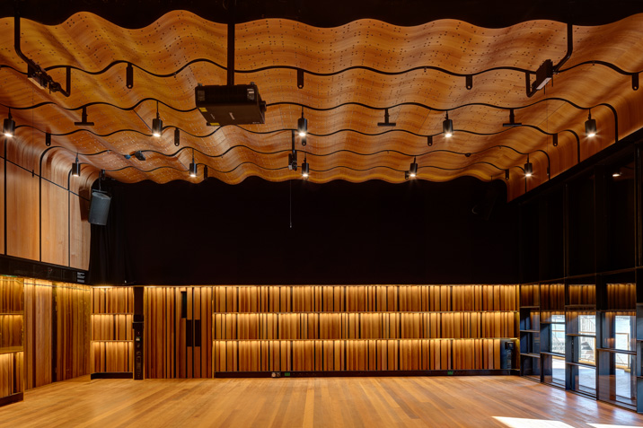Studio showing stylised wavy wood panels providing acoustic excellence for rehearsals