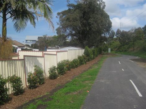 Bike track lined with fence and bushes