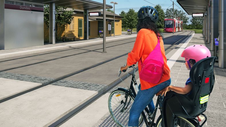 Parramatta Light Rail graphic of mother bike rider with child on back waiting at station crossing