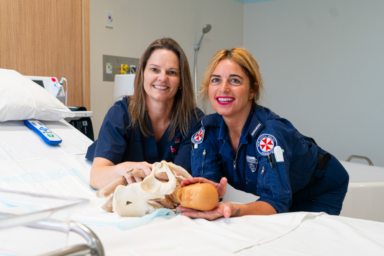 A midwife conducts training with a paramedic