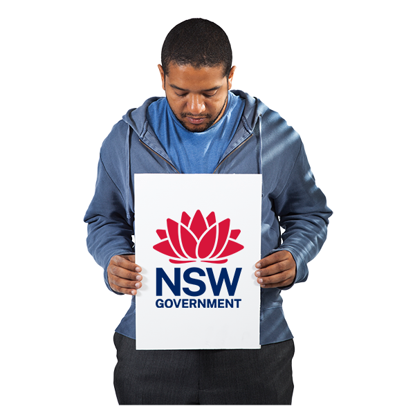 man holding placard of NSW state logo