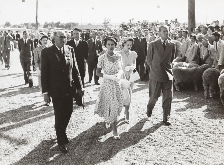 Black and white photo of The Queen and visting Dubbo, walking among crowds outside with the Duke of Edinburgh 
