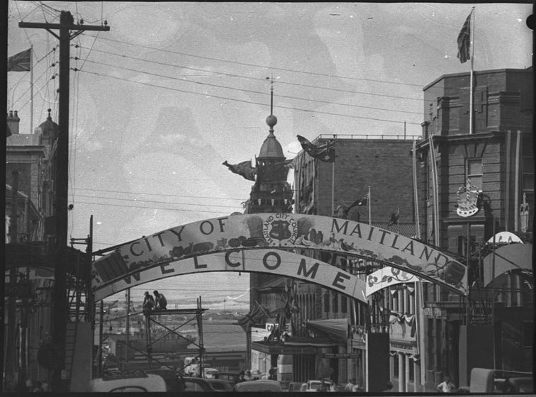 Black adn white photo of the town of Maitland, ready for the Queen's visit in 1954 with decorations