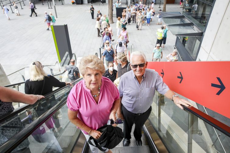seniors travelling up escalator to festival 