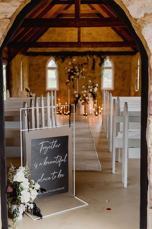 A sign welcoming guests to the ceremony at the chapel.