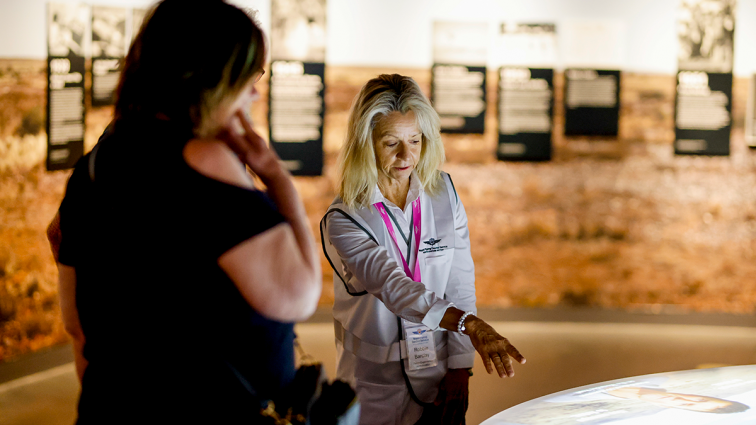 flying doctors volunteer showing a visitor an exhibit