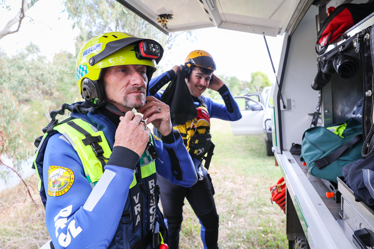 two members of the volunteer rescue association putting on rescue gear