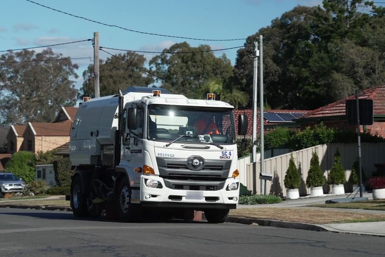 A street sweeper on a suburban road, with Asset AI technology installed.