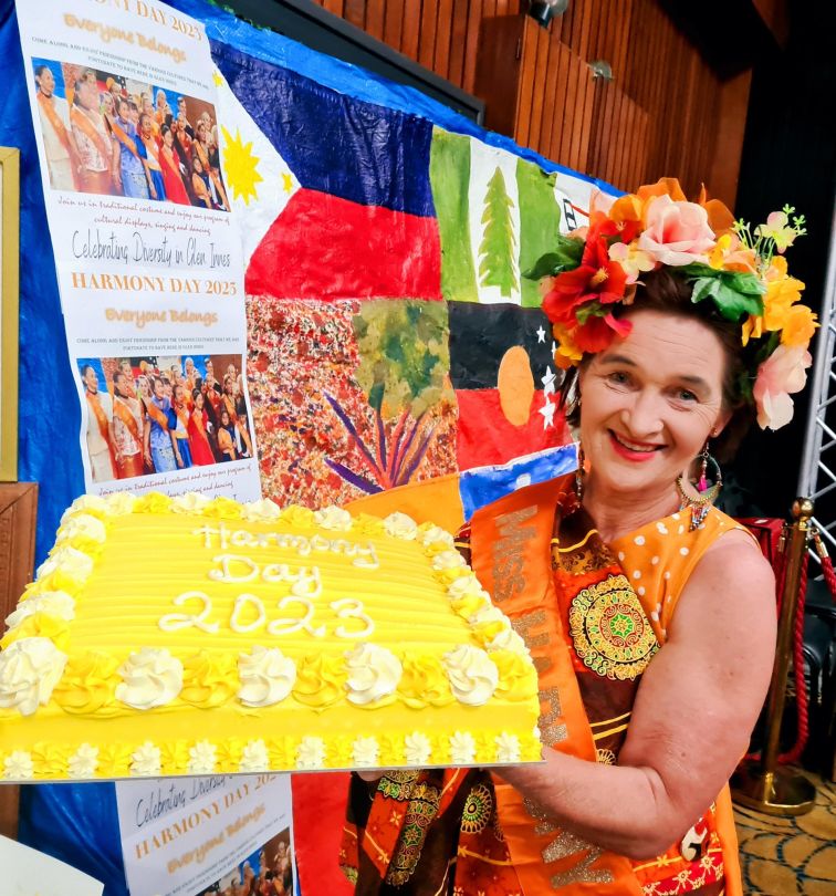 Woman holding up cake in competition