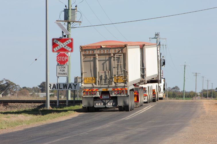 A truck crosses railway tracks at a level crossing in Narromine, that has had smart signage with flashing LED lights installed.