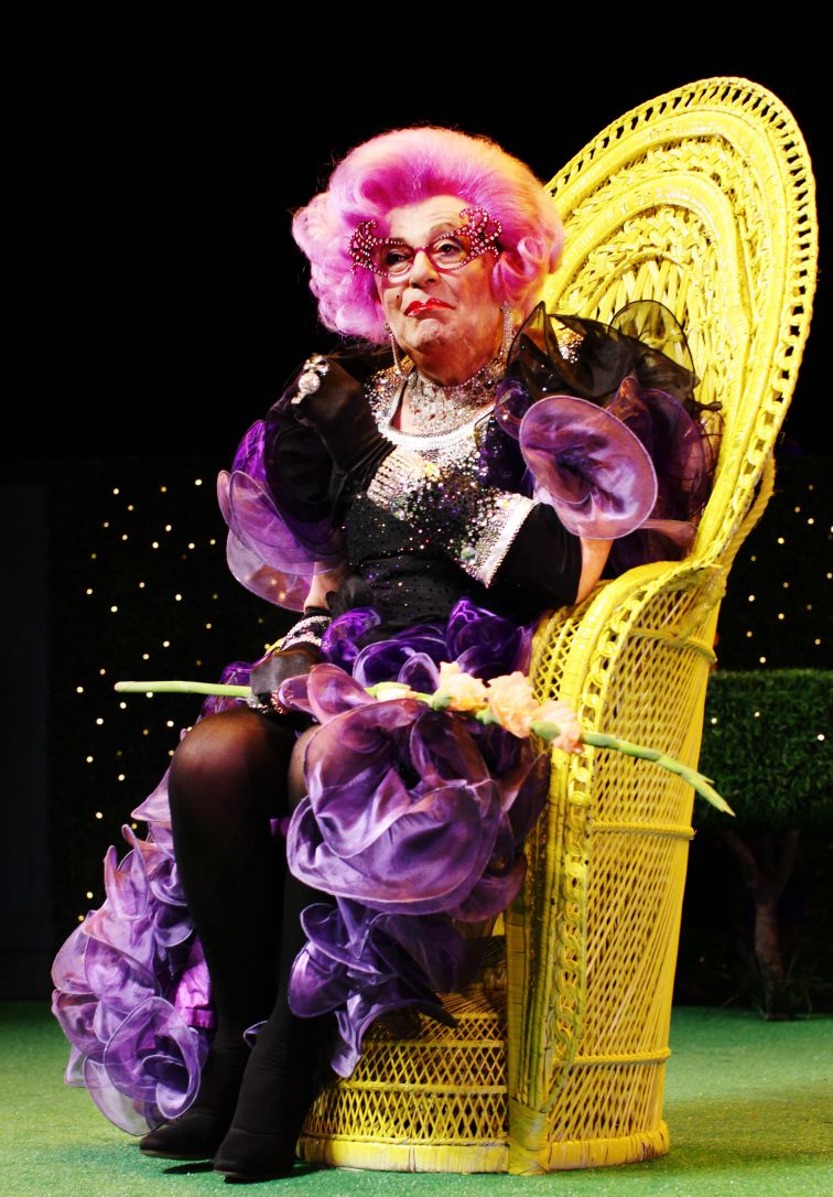 Dame Edna Everage holding a press call.