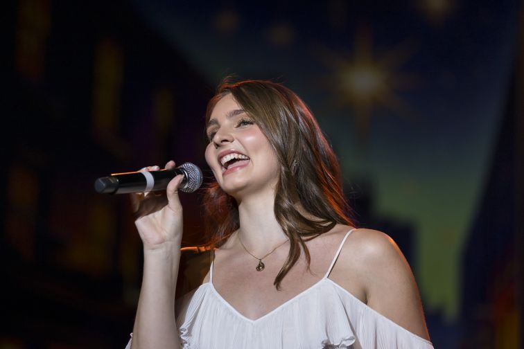 Liz Player singing on stage
