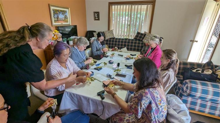 Group of women at table making craft