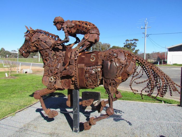 A scrap metal sculpture of a jockey riding a horse.