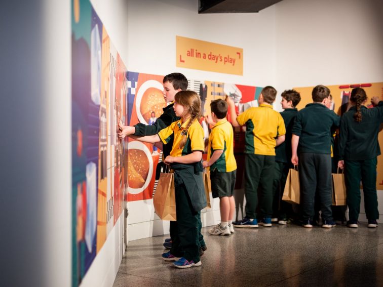 School children looking at All in a Day's work exhibition