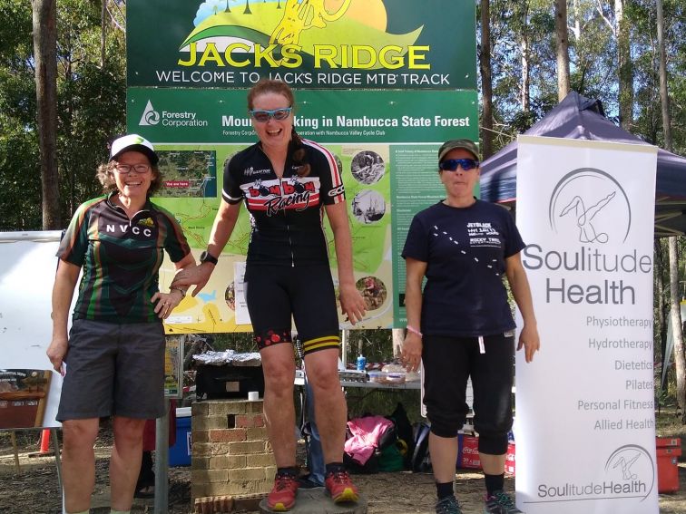 Three women on the podium at Jacks Ridge after competing in the Jills