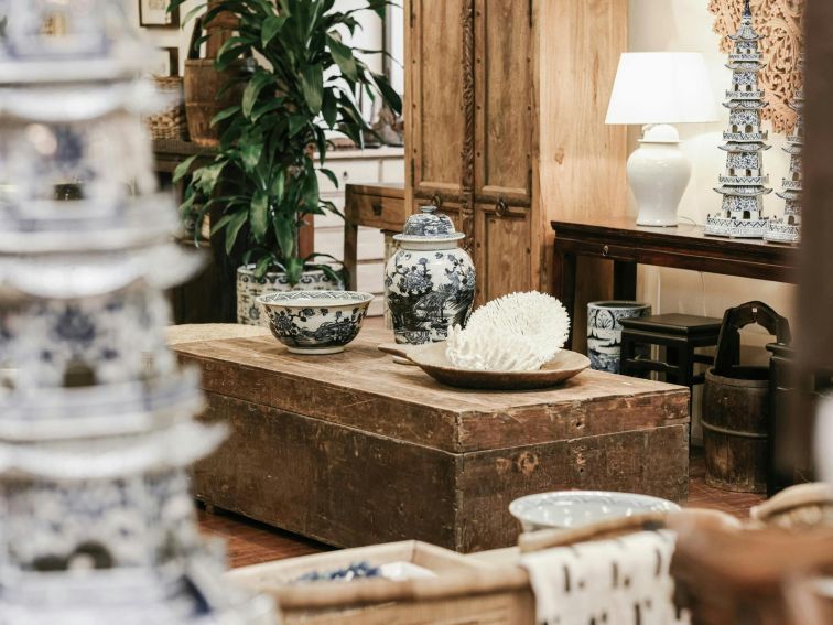 Blue and white porcelain vessels and pagodas, vintage timber furniture, sustainably sourced coral.