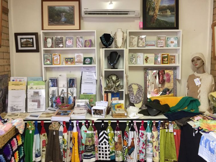 Display of handmade jewellery, towels, cards, kniteed jumpers and history  books