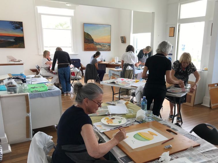 A group of people participate in an art workshop.
