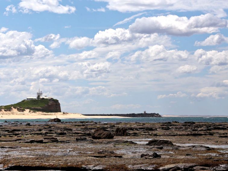 Nobbys Beach leading up to Nobbys Lighthouse on the south entrance of the Port of Newcastle
