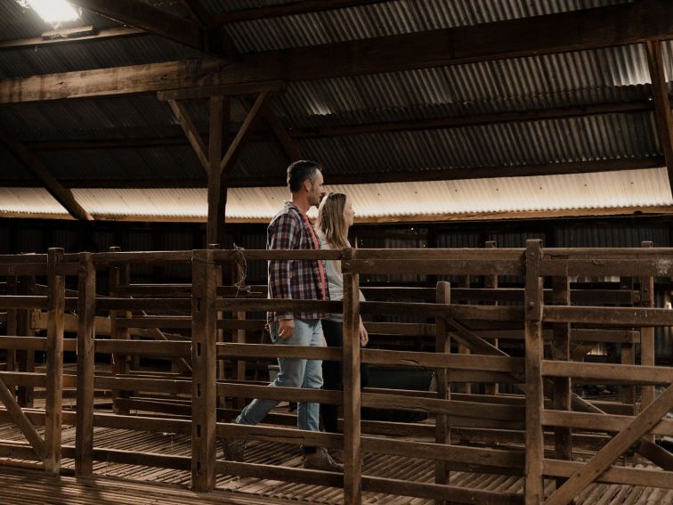 couple walking through shearing shed