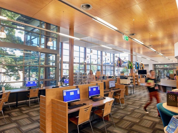 Thirroul Library interiors with computer workstations and large windows.