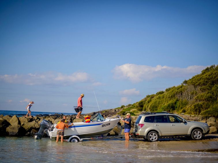 Family launches their boat at Kioloa Beach.