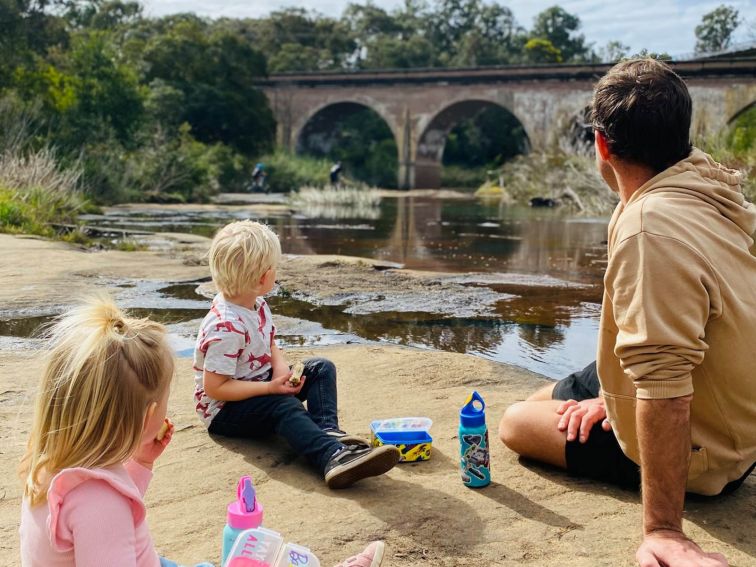 Family sitting down infront of Bargo Viaduct